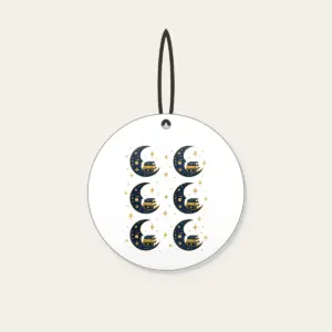 Crescent Moon with a Stack of Books Ceramic Ornament in white: A crescent moon holds a small stack of books among tiny stars in navy and gold.