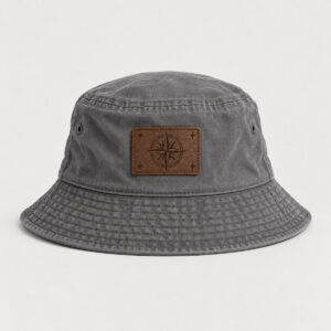 Grey Compass Rose Engraved Bucket Hat with engraved-look artwork on a rectangular leather patch of a compass rose and four tiny stars in cream and brown, Rec_RDBrown patch, Grey hat