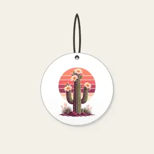 Flowering Saguaro and Striped Sun Ceramic Ornament in white: A flowering saguaro cactus stands against a striped sunset sun in coral, plum and cream.
