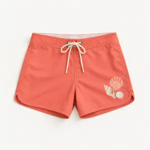 Seashell Trio Board Shorts with compact print of a trio of shells in coral, sand and white on one front thigh panel, away from the seams and hem