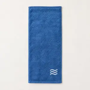 Wave Border Embroidered Bath Towel with three rolling white wave lines embroidered in a compact panel near one end