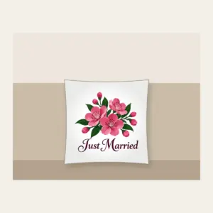 Cherry Blossoms and Just Married Wording Pillow in white: A cluster of cherry blossoms in deep rose pink and dark green, with the words “Just Married” in dark plum below.