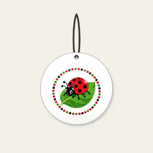 Ladybug on a Leaf Ceramic Ornament in white: A cheerful ladybug rests on a green leaf inside a polka-dot border in red, black and green.
