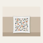 Chip Terrazzo in Terracotta and Navy Pillow in white: An all-over terrazzo of chips in terracotta, sage, navy and cream on a warm white field.