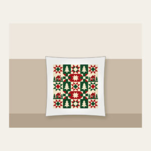 Cabin, Tree and Star Patchwork Pillow in white: Patchwork squares hold simple cabin, tree and star motifs in red, cream and green.
