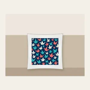 Origami Cranes on Navy Pillow in white: Folded paper cranes in coral, teal and cream scatter across a navy ground.