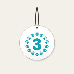 Teal Paw Circle with Number Three Ceramic Ornament in white: A ring of small white paw marks on teal circling the number “3”.