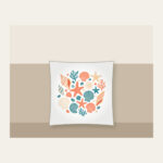 Scattered Shells and Starfish on Sand Pillow in white: Coral, cream and teal shells and starfish are tossed across a pale sand background.