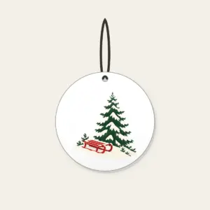 Red Sled on a Snowy Hill Ceramic Ornament in white: A small red sled on a snowy hill beside a tall pine in cream, red and green.