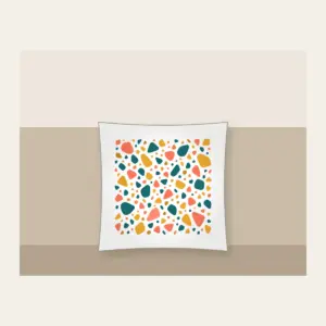 Coral, Teal and Mustard Terrazzo Pebbles Pillow in white: All-over terrazzo pebbles in coral, teal and mustard on a cream ground with clear breathing room.