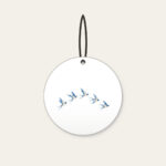 Five Swallows in a Gentle Arc Ceramic Ornament in white: Five swallows in cream and sky blue fly in an arc along a fine dotted trail.