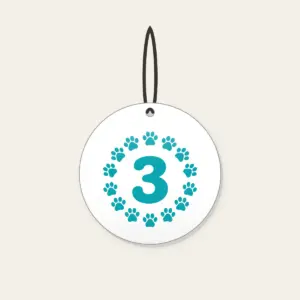 Teal Paw Circle with Number Three Ceramic Ornament in white: A ring of small white paw marks on teal circling the number “3”.