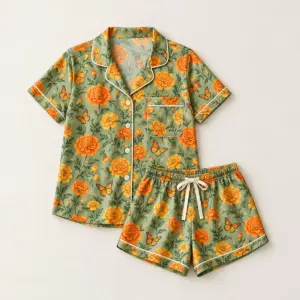 Marigold Meadow Satin Short Set with all-over repeat of marigolds and small butterflies in orange and yellow on a sage ground
