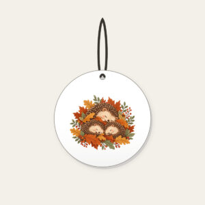 Sleeping Hedgehogs in Autumn Leaves Ceramic Ornament in white: Little hedgehogs curl up asleep among fallen leaves in brown, rust and sage.
