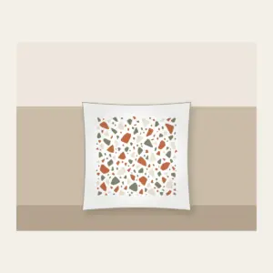 Terracotta and Sage Terrazzo Chips Pillow in white: Terrazzo chips scattered in terracotta, sage and cream.