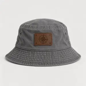 Grey Compass Rose Engraved Bucket Hat with engraved-look artwork on a rectangular leather patch of a compass rose and four tiny stars in cream and brown, Rec_RDBrown patch, Grey hat