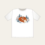 Sleeping Fox Among Snowy Pines T-Shirt in white: A fox curled asleep in a snowbank with tiny pines, in rust, cream and slate blue.