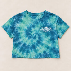 Lagoon Daydream Tie-Dye Crop Tee with small white chest print of a spiral seashell crossed by two delicate curling ocean waves