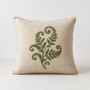 Embroidered Fern Pillow with a curling fern frond embroidered in green thread across the centre