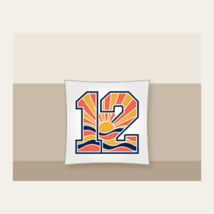 Sunrise Bands Number 12 Pillow in white: Sunrise bands in coral, gold and navy with the number “12” and no other text.