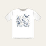 Herons and Reeds in Grey-Blue T-Shirt in white: Herons stand among reeds in grey-blue and cream in an all-over pattern.