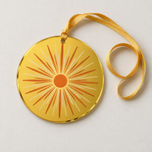 Sunburst Mirror Ornament with a round yellow mirror acrylic ornament printed with a sunburst of thin rays in cream and burnt orange, small circle at the center