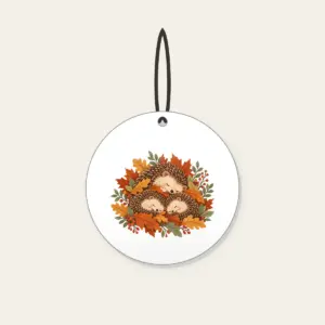 Sleeping Hedgehogs in Autumn Leaves Ceramic Ornament in white: Little hedgehogs curl up asleep among fallen leaves in brown, rust and sage.