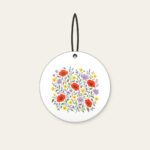 Wildflower Scatter on Sage Ceramic Ornament in white: Wildflowers in lavender, poppy red and butter yellow scatter over a sage ground.