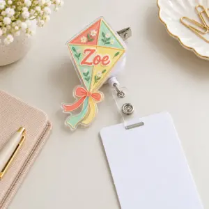 Kite-shaped two-layer acrylic badge reel in coral and mint with alligator clip