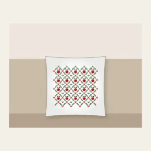 Orchard Diamond Lattice Pillow in white: A diamond lattice with small apple and leaf motifs in red, cream and green.