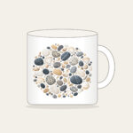 Beach Pebbles and Tiny Shells Mug in white: Pebbles and tiny shells in sand, slate and white are scattered across the artwork.