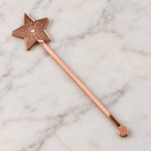 Rose gold mirror acrylic drink stirrer with a star-shaped head and printed sparkler motif