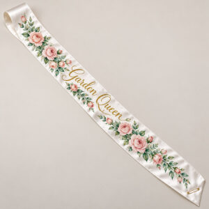 Garden Queen Satin Sash with a diagonal garland of roses and leaves in blush and green with the words "Garden Queen" in gold script