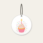 Candlelit Cupcake with Sprinkles Ceramic Ornament in white: A cupcake with a lit candle and scattered sprinkles in pink, mint and gold.