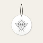 Moth, Stars and Crescent Moon Linework Ceramic Ornament in white: A fine-line moth rests among tiny stars and a crescent moon in black.