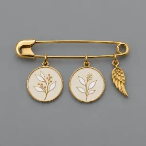 Decorative metal pin with two botanical photo charms and a separate wing accent