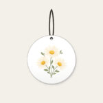 Three Daisies in Butter Yellow Ceramic Ornament in white: Three daisies with tiny leaves in cream, butter yellow and sage.
