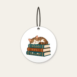 Cat Napping on Three Books Ceramic Ornament in white: A cat curled up asleep on a stack of three books, in warm brown and teal.