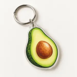 Avocado Pit Acrylic Keychain with an avocado half in leaf green with a warm brown pit and soft cream highlight