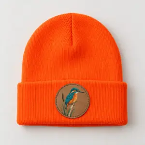 Kingfisher Patch Beanie with a small kingfisher on a reed printed on the patch in teal and orange