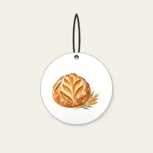 Sourdough Loaf and Wheat Sprig Ceramic Ornament in white: A round scored sourdough loaf with a small wheat sprig in golden brown, cream and sage.