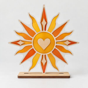 Sunbeam Suncatcher Standee with suncatcher panel with concentric sunburst rays in amber, tangerine and gold with a small heart in the centre