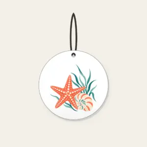 Starfish, Spiral Shell and Sea Grass Ceramic Ornament in white: A starfish, a spiral shell and a sprig of sea grass in coral, cream and teal.