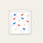 Paper Planes on Dotted Trails Mug in white: Little paper planes trail dotted paths in blue, coral and cream.