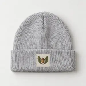 Tiny Acorn Patch Cuffed Beanie with a small patch with an acorn and two oak leaves in brown and moss green