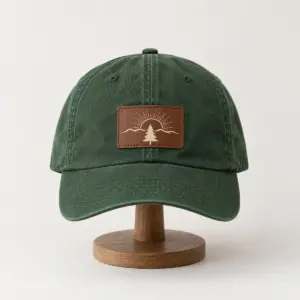 Forest Trail Patch Dad Hat with a rectangular brown patch printed with a small cream pine and rising sun