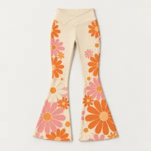 Retro Daisy Flare Leggings with large retro daisies running up the flare in orange, pink and cream