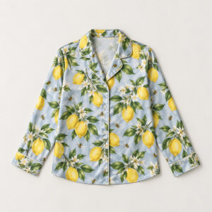 Lemon Grove Satin Pajama Shirt with all-over repeat of lemons, glossy leaves and tiny bees in yellow and green on a pale blue-grey ground