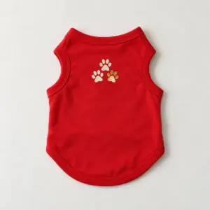 Red Paw Prints Pet Tank Top with compact paw-print cluster of three small paws on the upper back panel in cream and gold