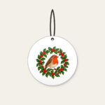 Robin in a Holly Wreath Ceramic Ornament in white: A robin perches in a holly wreath in red, brown and green.